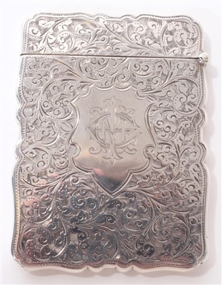 Lot 306 - Victorian silver card case of shaped rectangular form, with engraved foliate decoration, engraved initials and hinged cover. (Birmingham 1894) Maker J.N.M 9.8cm overall length.