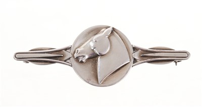 Lot 559 - Georg Jensen silver brooch with a circular plaque depicting a horse’s head. Signed and numbered with model number 247. Length 52mm