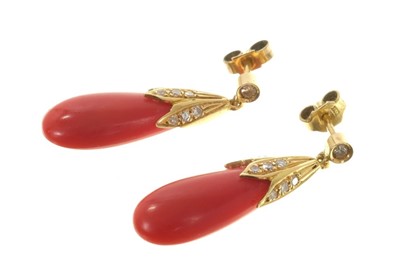 Lot 562 - Pair of coral and diamond pendant earrings, each with pear shape coral drop and diamond set caps, 30mm.