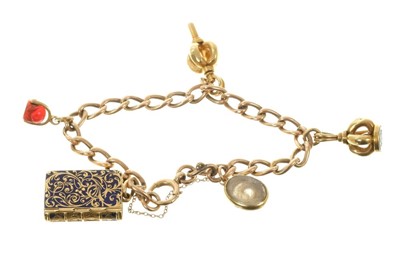 Lot 571 - Victorian gold charm bracelet with a collection of five charms to include a Victorian gold and blue enamel vinaigrette/mourning locket.