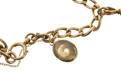Lot 571 - Victorian gold charm bracelet with a collection of five charms to include a Victorian gold and blue enamel vinaigrette/mourning locket.