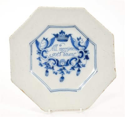 Lot 149 - Rare 17th century Delft blue and white Merryman rhyme plate of octagonal form, with painted crowned cartouche with dragon, human mask, scrolls and swags ‘All Merryment goes downe’, 20cm wide. Merry...