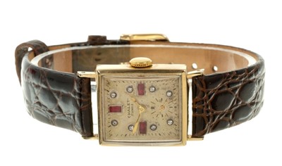 Lot 615 - Art Deco 14K gold wristwatch, the rectangular dial with jewelled hour markers and subsidiary seconds in a tank shape 14K gold case on leather strap. Case 21mm x 24mm