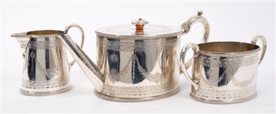 Lot 400 - Victorian Silver three piece tea set of drum form, with engraved decoration