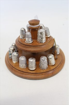 Lot 3511 - Collection of silver and white metal thimbles on two tier wooden stand