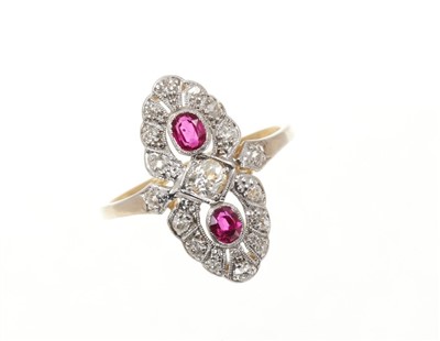 Lot 648 - Art Deco ruby and diamond cocktail ring, the openwork plaque with a central old cut diamond flanked by two oval mixed cut rubies within a border of old cut diamonds all in platinum mille grain sett...