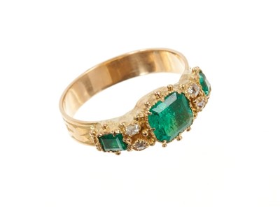 Lot 649 - Victorian style emerald and diamond ring with three step cut emeralds and four old cut diamonds all in closed-back gold setting on engraved gold shank. Finger size L1/2.