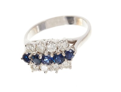 Lot 669 - Sapphire and diamond cluster ring with a triple row of blue sapphires and brilliant cut diamonds in claw setting on 18ct white gold shank, estimated total diamond weight approximately 0.75cts, fing...