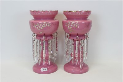 Lot 2026 - Pair of Victorian pink glass lustres with enamelled floral decoration and prismatic drops, 37cm in height