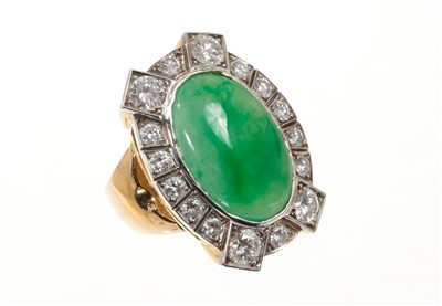 Lot 651 - Jade and diamond cluster ring with an oval green jade cabochon surrounded by brilliant cut diamonds in 18ct gold setting. Finger size approximately L-M.