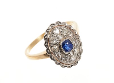 Lot 670 - Art Deco style sapphire and diamond cluster ring, the oval bezel with a central mixed cut blue sapphire surrounded by old cut and brilliant cut diamonds, openwork border on gold shank. Finger size...