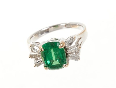 Lot 650 - Green garnet and diamond cocktail ring with a cushion cut green tsavorite garnet weighing approximately 3.24cts flanked by six baguette cut diamonds to the shoulders on white gold shank. Finger siz...