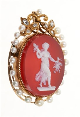 Lot 698 - Carved hardstone cameo pendant depicting a classical female, in gold mount with seed pearl border and rose cut diamond foliage.