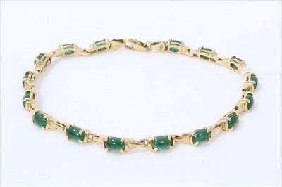 Lot 3359 - Gold (stamped 585) jade/ green hardstone cabochon bracelet