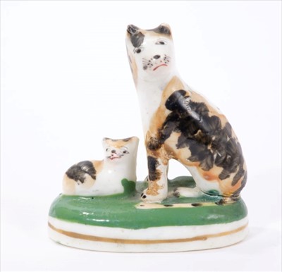 Lot 270 - Mid 19th century Staffordshire porcelaneous model of a tortoiseshell-coloured cat and kitten