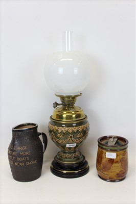 Lot 2050 - Edwardian Royal Doulton oil lamp, Edwardian Doulton tobacco jar and a Doulton Slater’s Patent ‘leather’ jug (3)
