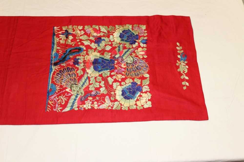 Lot 3053 - Chinese embroidered silk banner. Flowers and peacocks worked in silk stain stitch with couched outlines. Blue cotton lining with black calligraphy.