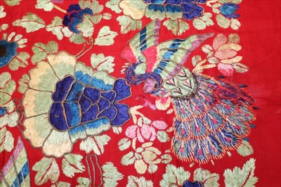 Lot 3053 - Chinese embroidered silk banner. Flowers and peacocks worked in silk stain stitch with couched outlines. Blue cotton lining with black calligraphy.