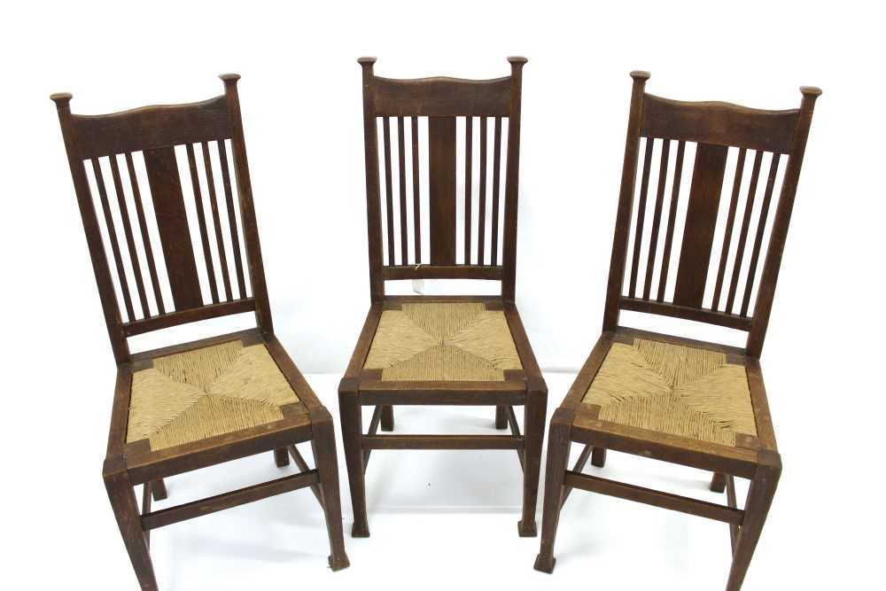 Lot 1721 - Charles Francis Annesley Voysey rare set of three oak and rush chairs with Sotheby's sales catalogue