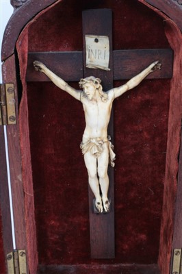 Lot 1162 - 19th century carved ivory crucifix in gothic mahogany case, together with another similar example