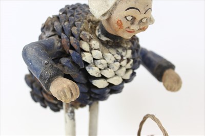 Lot 2033 - Unusual figure of a stooping lady, with pottery head and arms, and body constructed from a painted pine cone. Paper label to base "made in France" approx 20cm in height