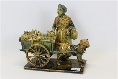 Lot 2034 - Unusual large pottery figure group of an elderly lady with a dog pulling a cart, approx 26cm in length