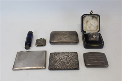 Lot 3510 - Four silver cigarette cases, silver vesta case, silver napkin ring in fitted case and blue glass double ended perfume bottle