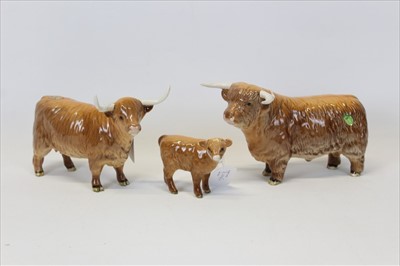 Lot 2045 - Beswick Cattle Comprising: Highland Bull, model No. 2008, Highland Cow, model No. 1740 and Highland Calf, model No. 1827D, all tan/brown gloss (3)