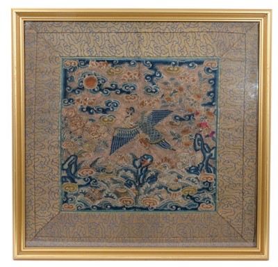 Lot 1221 - 18th/19th century Chinese silk rank badge, finely embroidered in silk and metal wire threads with Phoenix, 26 x 27cm in cloud border and glazed frame