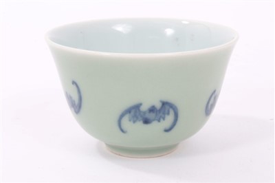 Lot 325 - Chinese celadon glazed tea bowl, decorated in underglaze blue with bats