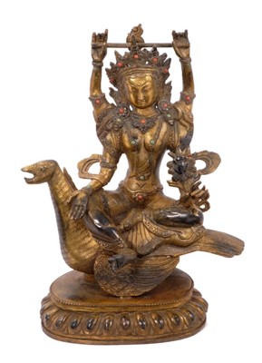 Lot 1191 - Antique Tibetan gilt bronze figure of Tara Sarawati riding a Hamsa bird