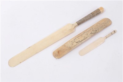 Lot 1127 - Antique carved ivory novelty paper knife, another smaller and carved bone stay busk