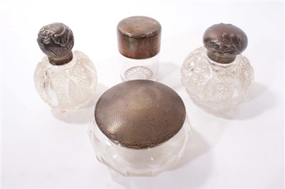 Lot 438 - Collection of four Victorian and later cut glass toilet jars with silver mounts