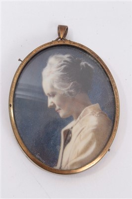 Lot 1187 - Early 20th century overpainted photographic portrait miniature on ivory