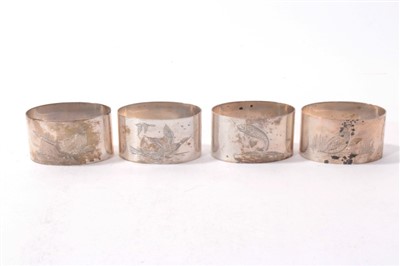 Lot 486 - Four silver napkin rings of oval form with engraved game bird and fish decoration