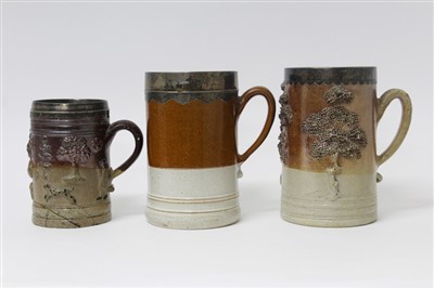 Lot 345 - A rare group of three 18th century English silver mounted salt glazed tankards