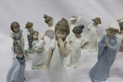 Lot 2091 - Fourteen NAO porcelain figures including girl with lamb, girl with hand mirror and girl with flowers