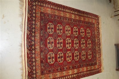 Lot 1776 - Large Afghan Carpet with geometric decoration on red ground