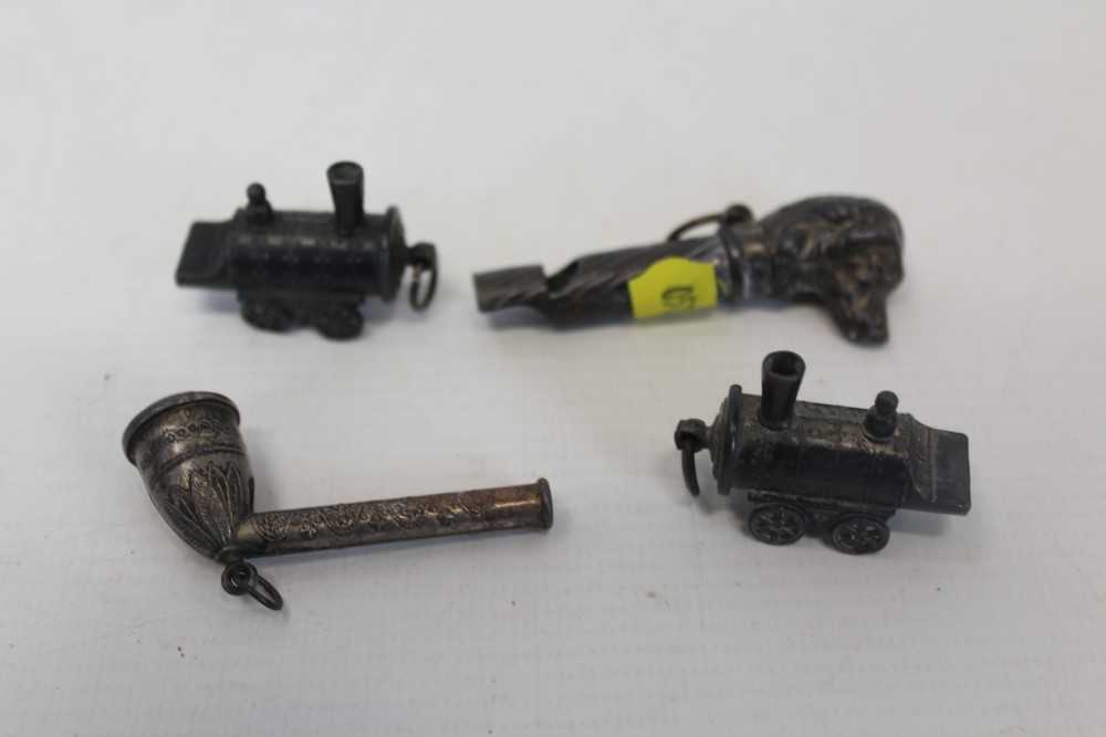 Lot 3522 - Four old novelty whistles, to include a dog's head, trains and a pipe (4)