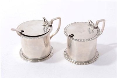 Lot 476 - Two similar Edwardian silver mustard pots with engraved crests