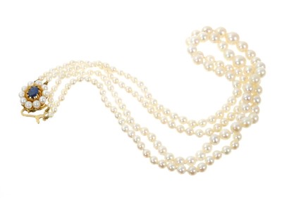 Lot 735 - A double strand of cultured pearls with gold clasp