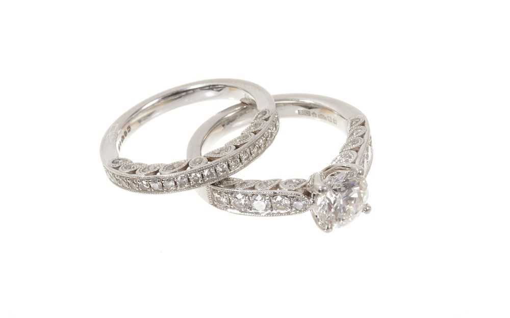Lot 618 - Diamond single stone ring with a round brilliant cut diamond weighing approximately 1.00ct in platinum setting, together with a matching wedding ring (2)