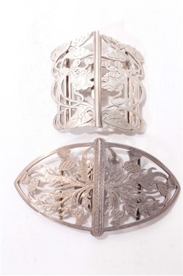 Lot 514 - Art Nouveau silver buckle, together with a silver buckle with thistle design