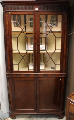 Lot 1769 - George III mahogany two height corner cupboard with astragal glazed doors above and two panelled doors below standing on bracket feet