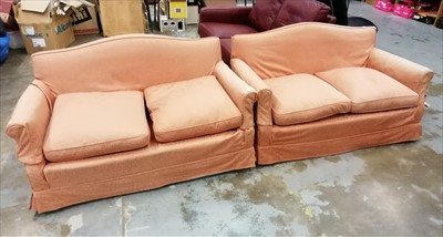 Lot 896 - Pair of traditional two seater sofas with feather cushions, upholstered in loose pink covers