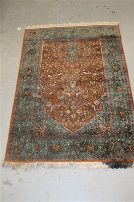 Lot 1775 - Kashan silk rug with bird and floral motifs on green and russet ground, 180cm x 122cm