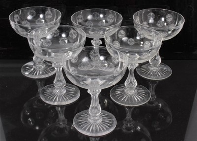 Lot 313 - Set of six good quality glass champagne bowls with cut snowflake motifs on cut and faceted stems, with star cut foot