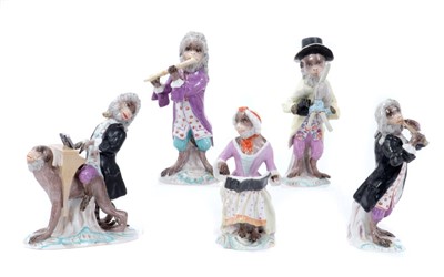 Lot 204 - Set of five late 19th century Dresden Monkey Band Figures, including piano player resting on monkey's back, bagpipe player, singer and flutists, on scrollwork rococo bases, some with underglaze blu...