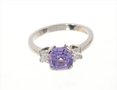 Lot 490 - Natural purple sapphire and diamond three stone ring with an octagonal cut natural purple Ceylon sapphire weighing 2.48cts flanked by two princess cut diamonds in platinum setting. Estimated total...