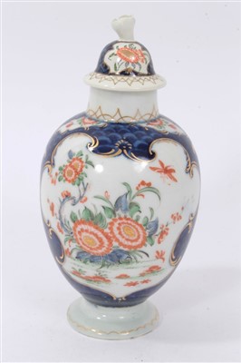 Lot 230 - Late 18th century Worcester tea caddy, decorated in polychrome enamels with floral patterns inside scrollwork cartouches, on a blue scale ground, the associated lid with flower knop, with underglaz...